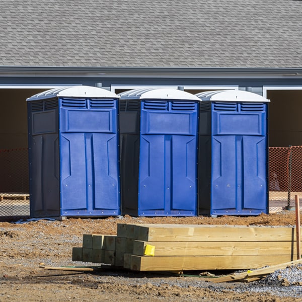 what is the cost difference between standard and deluxe portable restroom rentals in Tabor